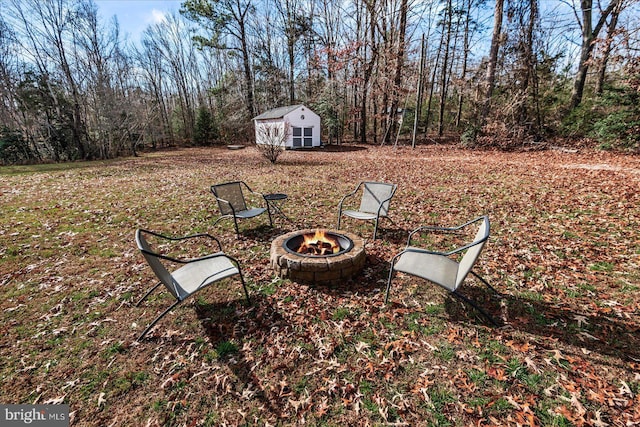 view of yard with a fire pit and a storage unit