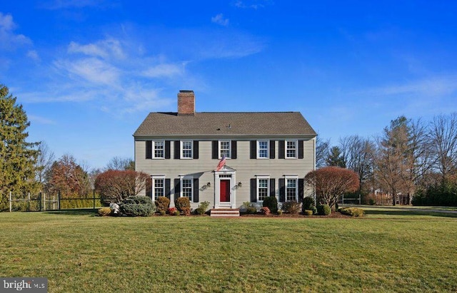 colonial-style house with a front lawn