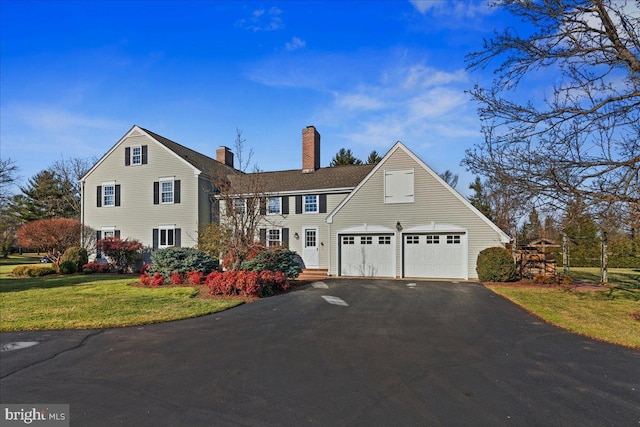 view of front of property featuring a garage and a front lawn