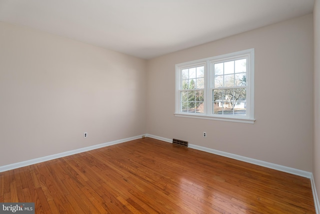 spare room featuring hardwood / wood-style flooring