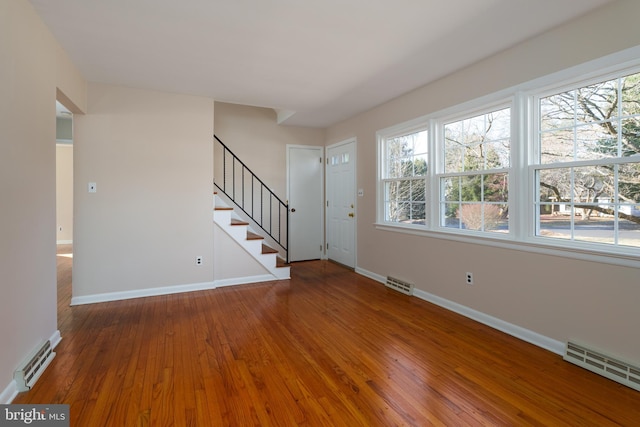 unfurnished living room with hardwood / wood-style floors