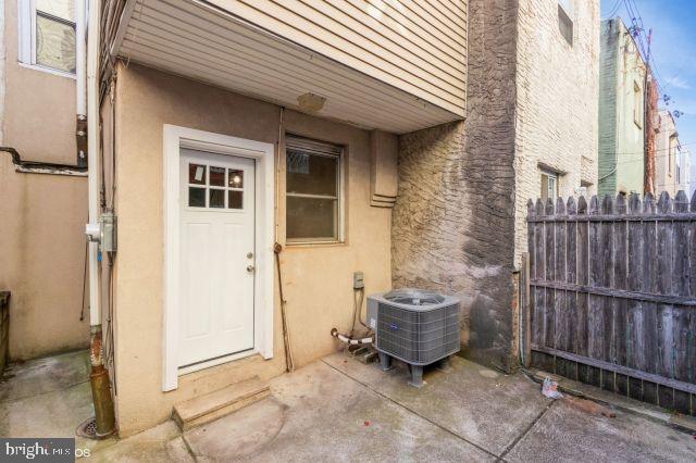 entrance to property featuring central air condition unit