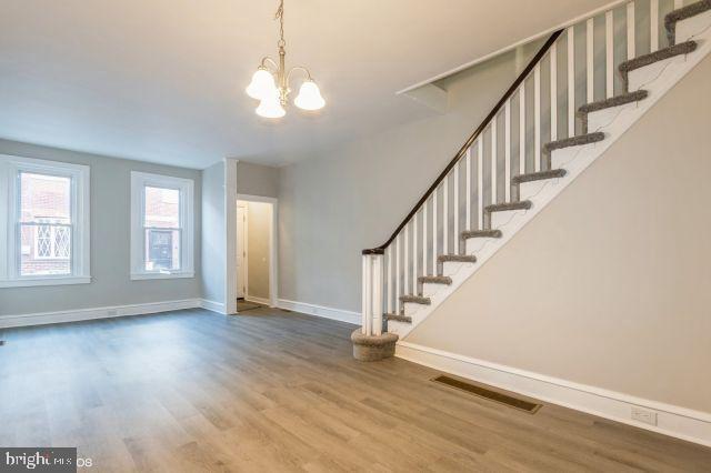 interior space featuring an inviting chandelier and hardwood / wood-style flooring