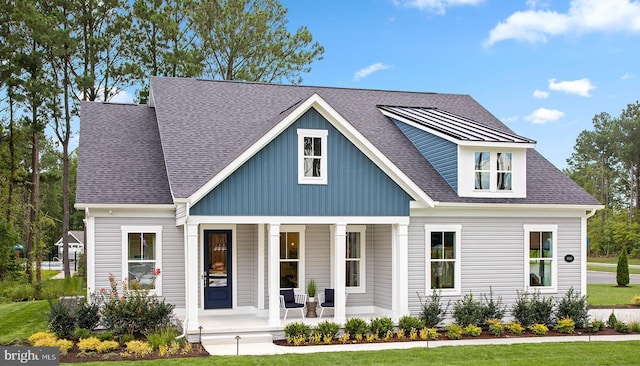 view of front of home featuring covered porch and a front yard