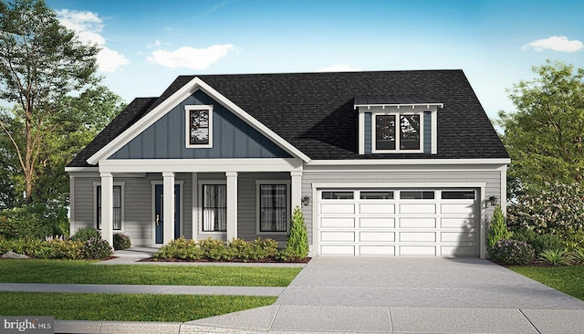 view of front of home featuring a front lawn, covered porch, and a garage