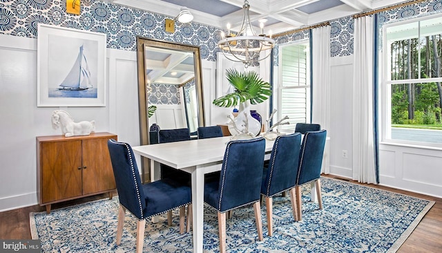 dining room featuring hardwood / wood-style floors, a chandelier, ornamental molding, and coffered ceiling