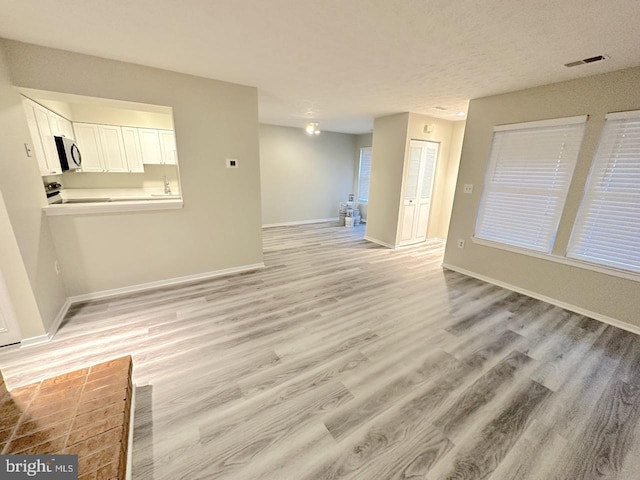 unfurnished living room with light hardwood / wood-style flooring