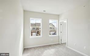 spare room with light colored carpet