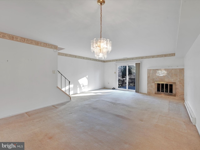 unfurnished living room with baseboard heating, a high end fireplace, carpet floors, and a chandelier