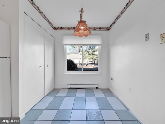 unfurnished dining area featuring baseboard heating and light tile patterned floors