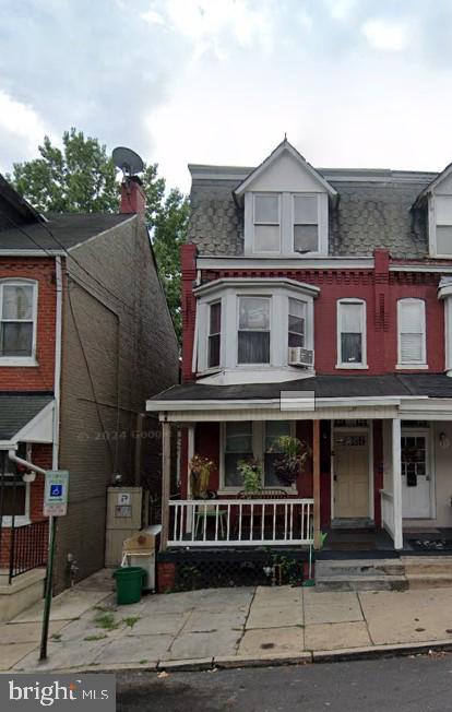 view of property with a porch and cooling unit