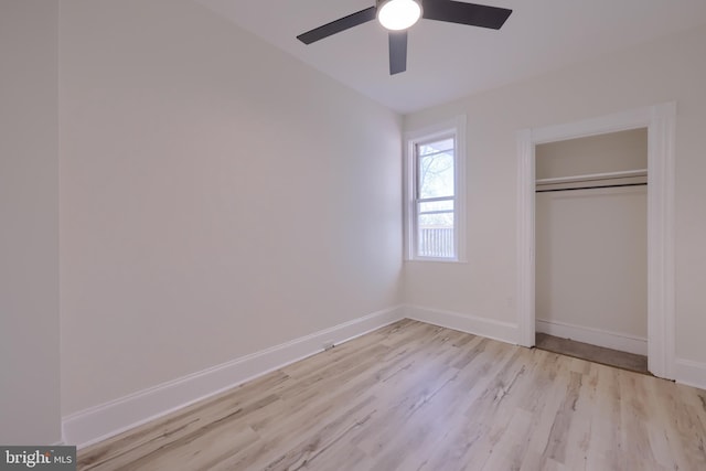 unfurnished bedroom featuring ceiling fan, a closet, and light hardwood / wood-style flooring