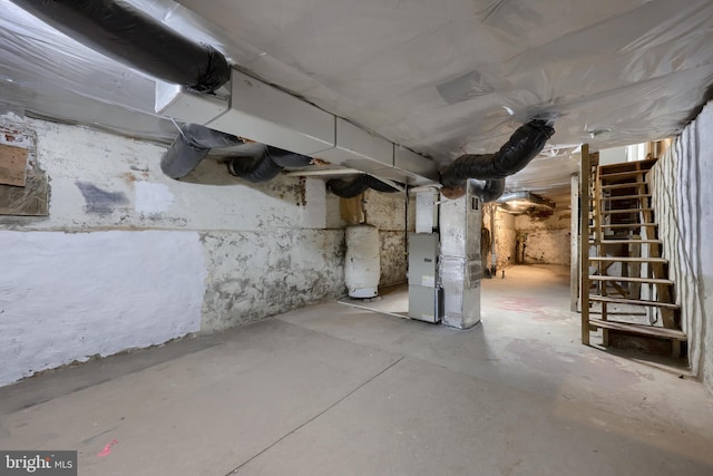 basement featuring heating unit and water heater