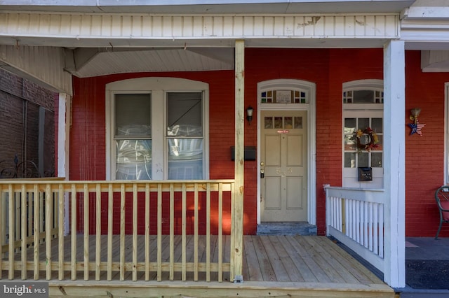 doorway to property featuring covered porch