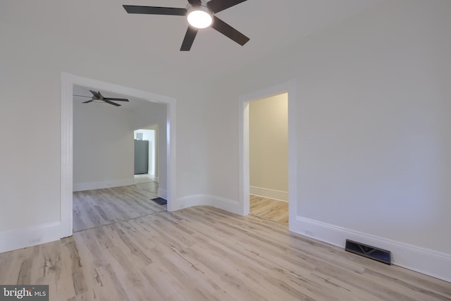 empty room with light hardwood / wood-style floors and ceiling fan