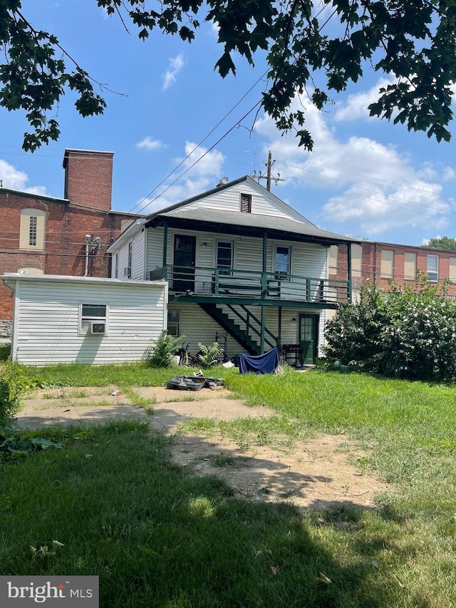 rear view of property with a lawn