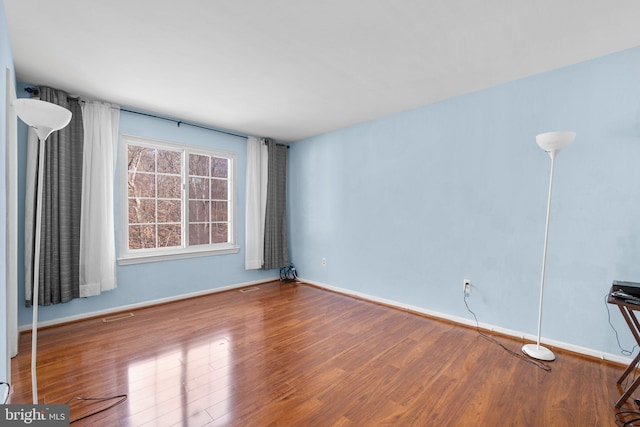 spare room with wood-type flooring