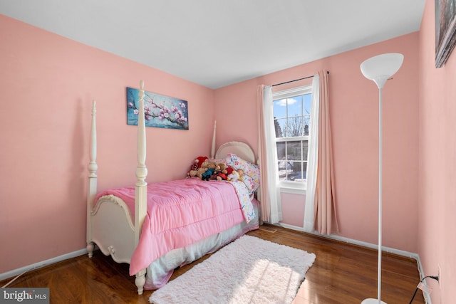 bedroom with dark hardwood / wood-style floors