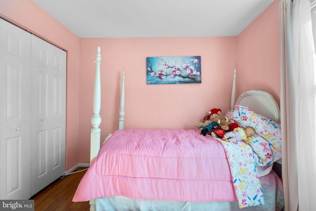 bedroom with hardwood / wood-style floors and a closet