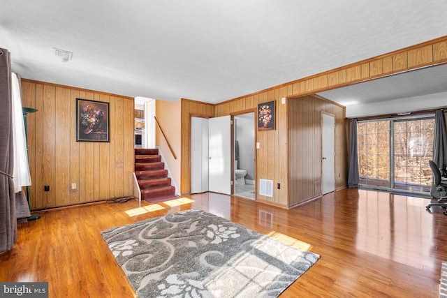 interior space featuring hardwood / wood-style floors and wooden walls