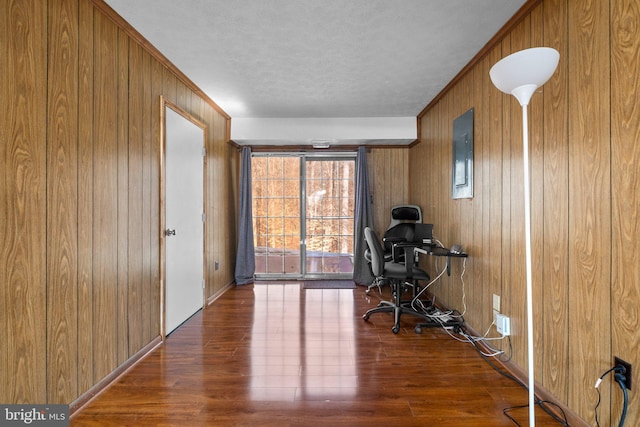 office featuring ornamental molding, dark hardwood / wood-style flooring, and wooden walls