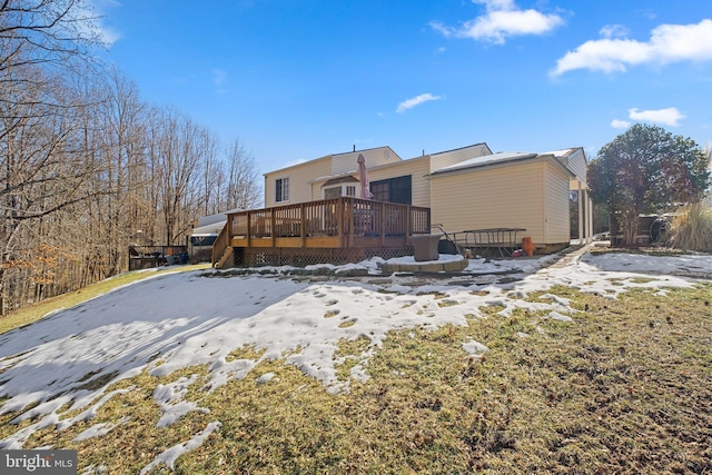 snow covered property featuring a deck