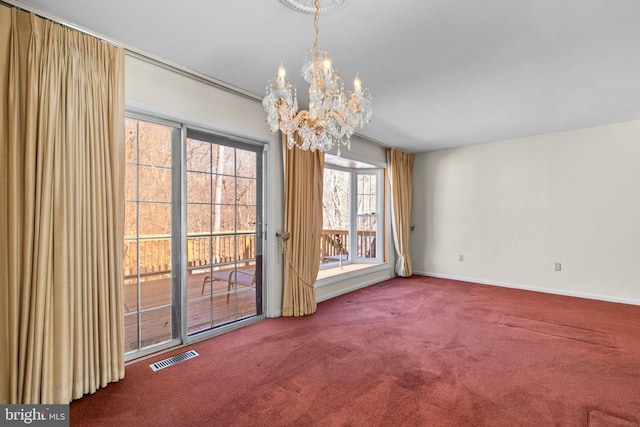 unfurnished dining area featuring a chandelier and carpet floors