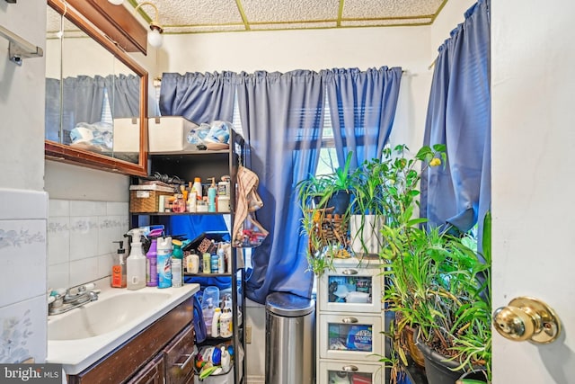 bathroom with vanity and tile walls