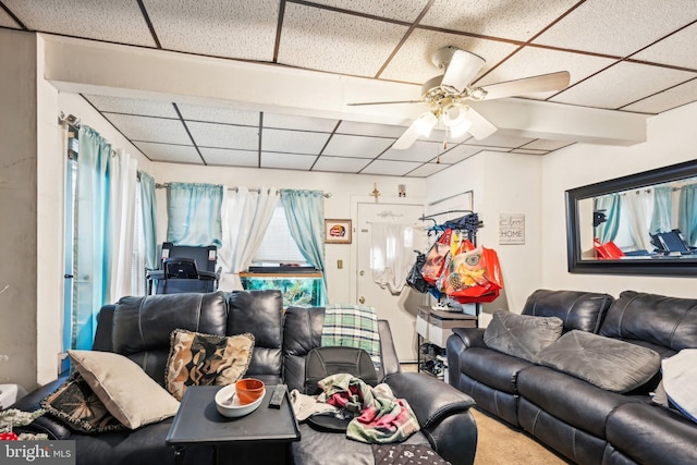 carpeted living room featuring a drop ceiling and ceiling fan