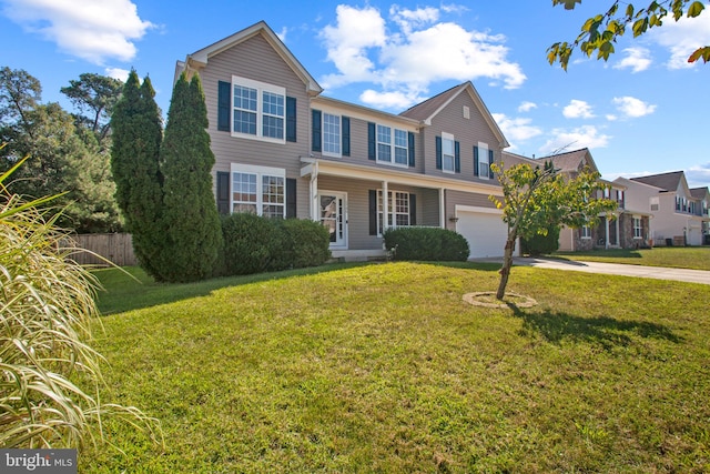 view of front of house with a porch, a front yard, and a garage