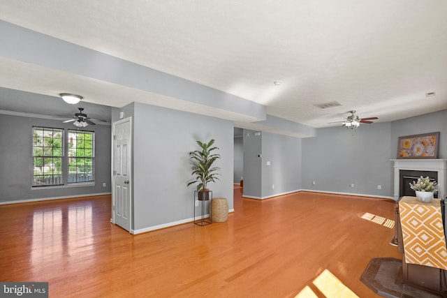 unfurnished living room with ceiling fan and hardwood / wood-style floors