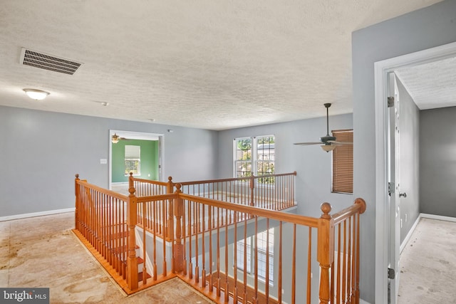 hallway featuring a textured ceiling