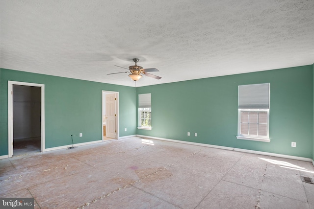 unfurnished room featuring a textured ceiling and ceiling fan