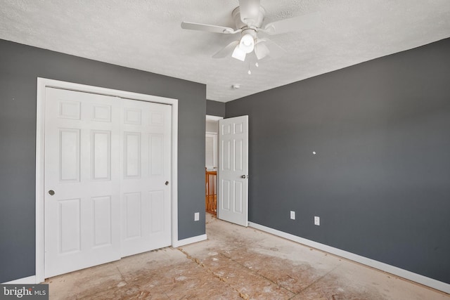 unfurnished bedroom with a textured ceiling, a closet, and ceiling fan