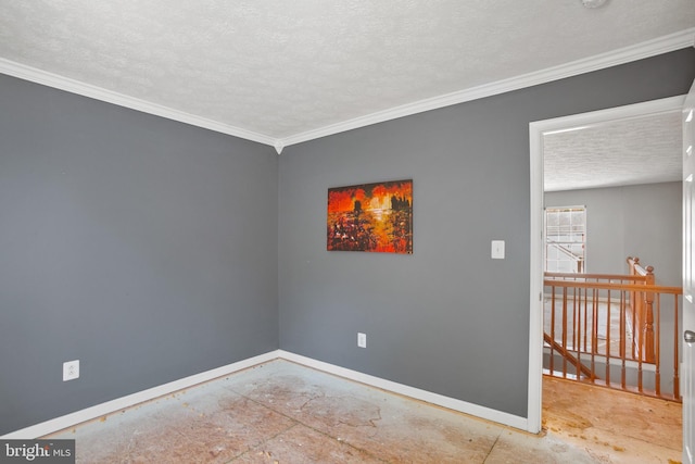 spare room with a textured ceiling and crown molding