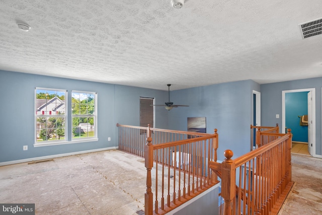 hallway featuring a textured ceiling