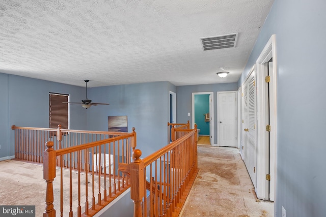 hallway featuring a textured ceiling