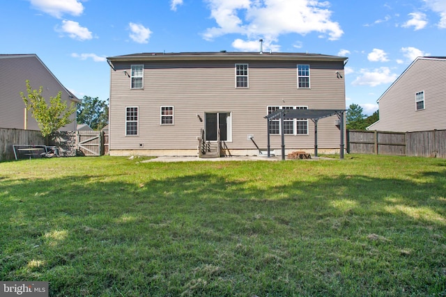 back of house featuring a pergola and a yard