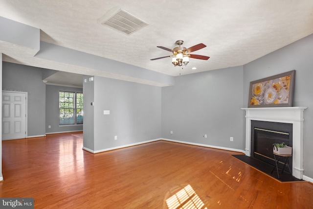 unfurnished living room featuring hardwood / wood-style floors, a textured ceiling, and ceiling fan