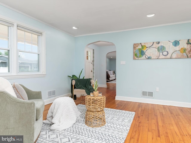 sitting room featuring hardwood / wood-style floors and ornamental molding