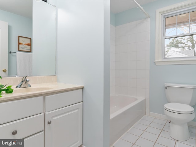 full bathroom with toilet, vanity, tile patterned floors, and tiled shower / bath