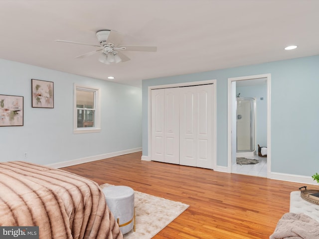 bedroom featuring light wood-type flooring, a closet, ceiling fan, and connected bathroom