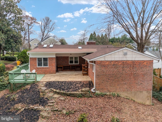 exterior space featuring a patio and a wooden deck