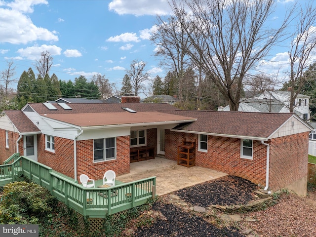 rear view of house with a patio and a deck