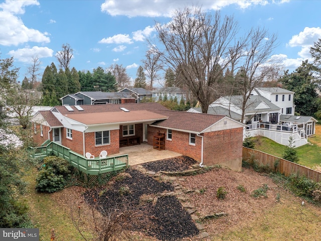 rear view of house featuring a patio and a wooden deck