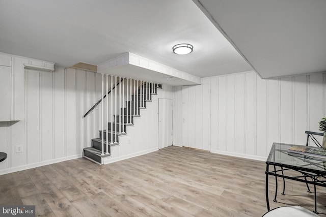 basement with light hardwood / wood-style flooring