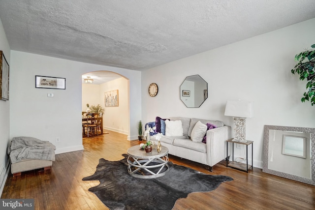 living room featuring a textured ceiling and hardwood / wood-style floors