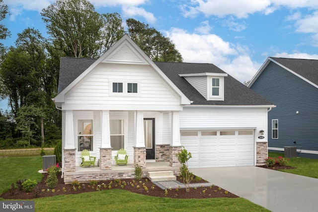 view of front facade featuring central AC, a front lawn, a porch, and a garage