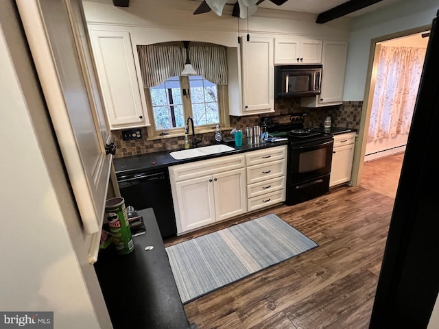 kitchen featuring tasteful backsplash, baseboard heating, dark wood-type flooring, sink, and black appliances