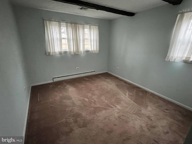 carpeted empty room with a textured ceiling and a baseboard heating unit